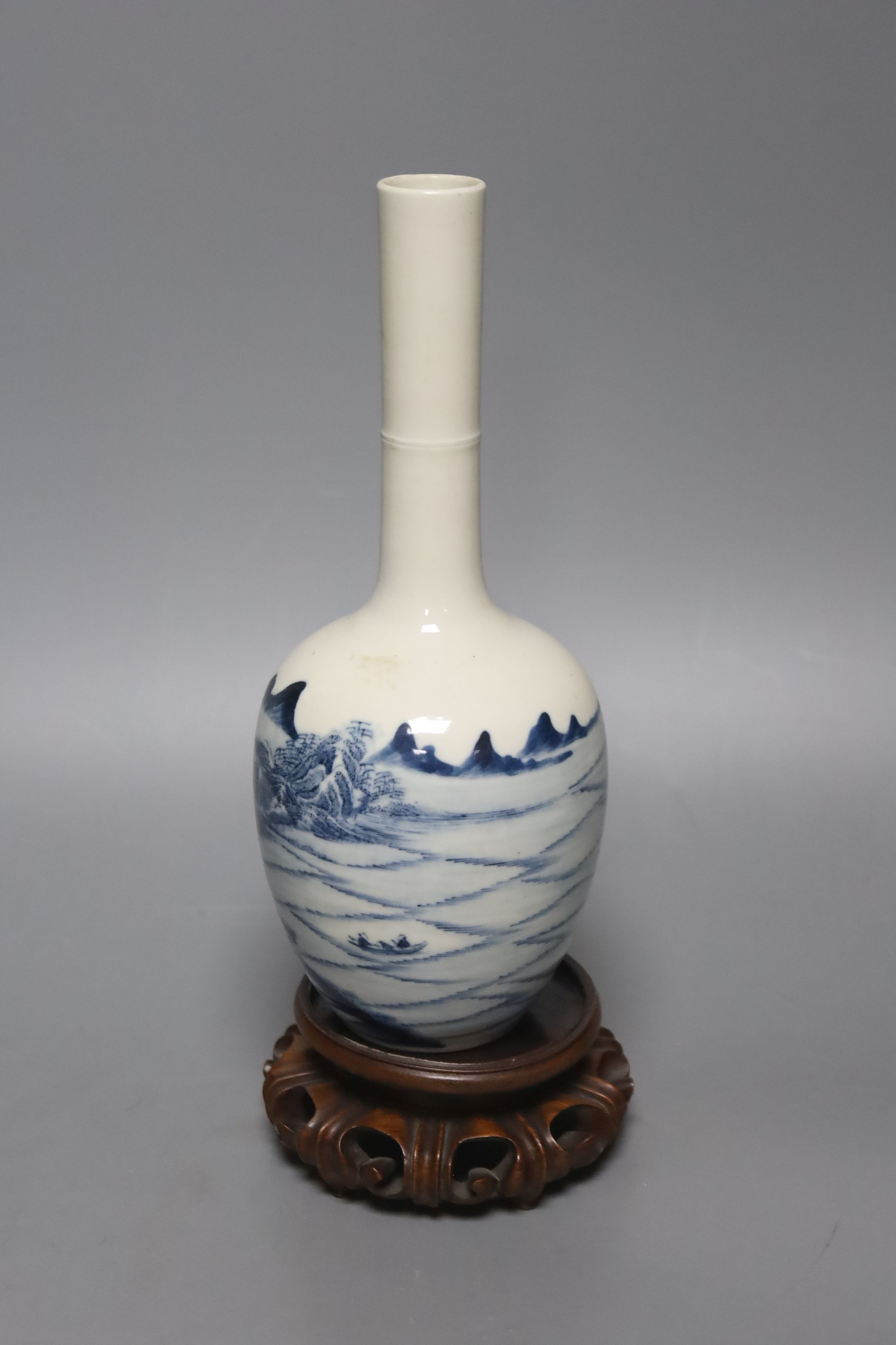 A Chinese blue and white bottle vase, with hardwood stand 23.5cm.